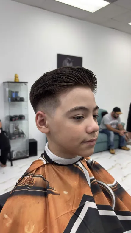 Barber finishing a fresh cut in the chair at Anthony's Dominican Barbershop, Cape Coral